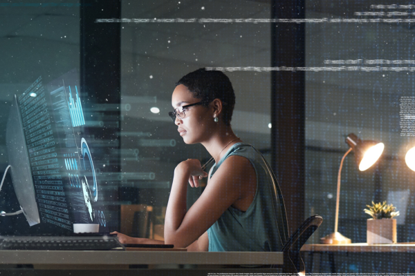 overlay-text-over-woman-working-at-desktop-computer-at-night-with-digital-display-getty-1569365282